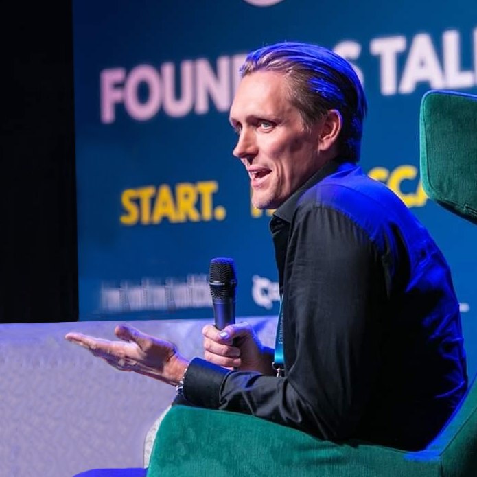 David Henzel speaking on stage